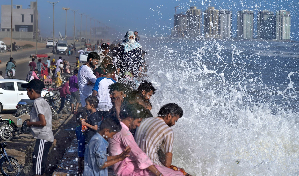 People enjoy high tide waves on the Arabian Sea, in Karachi, Pakistan, on June 11, 2023. (AP)