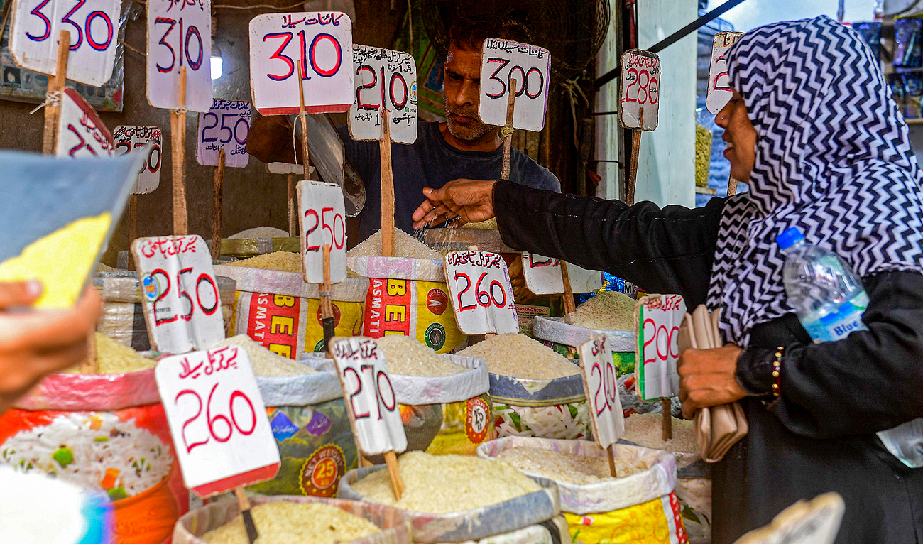 A customer buys rice at a wholesale shop in Karachi on June 8, 2023. (AFP/File)