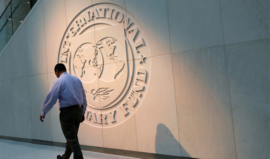 A man walks past the International Monetary Fund (IMF) logo at its headquarters in Washington, U.S., May 10, 2018. (REUTERS/File)