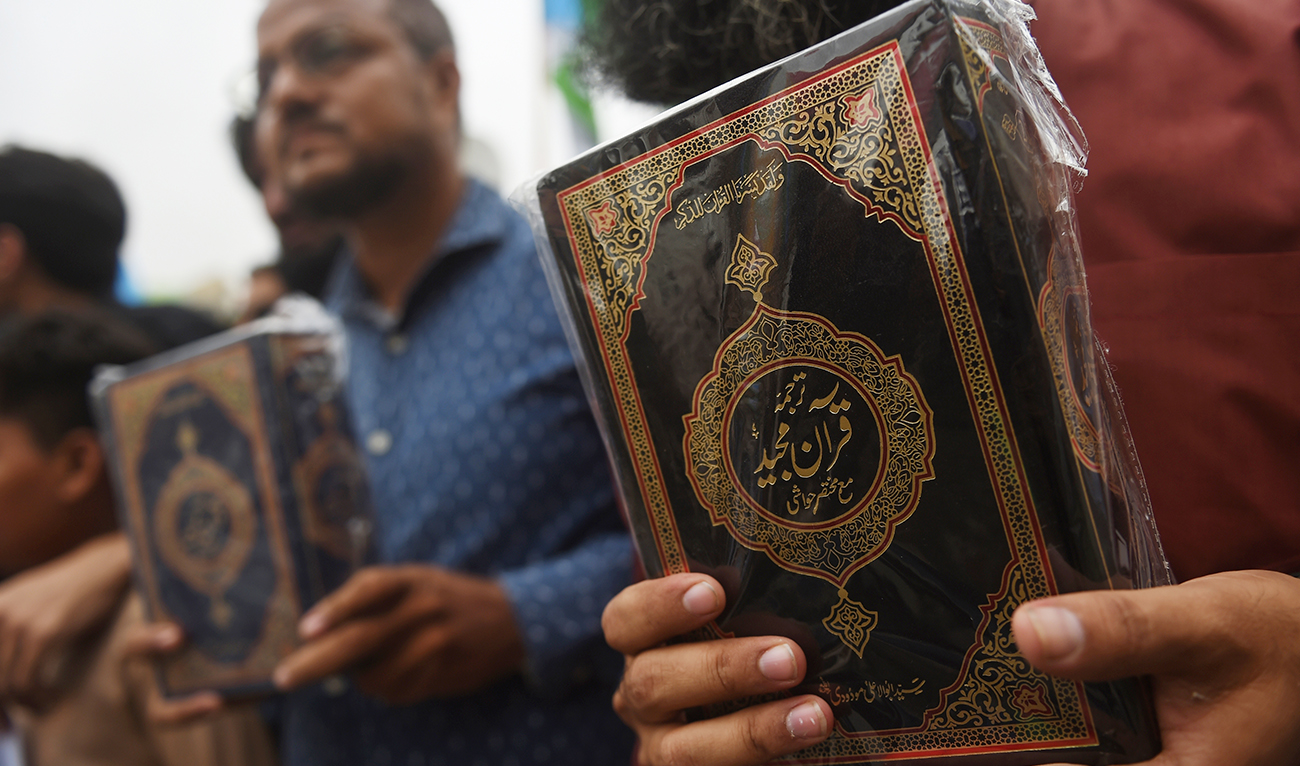 Activists of the right-wing religious Jamaat-e-Islami (JI) party hold copies of the Koran during an anti-Sweden demonstration in Karachi on July 5, 2023, following the burning of the Koran outside a Stockholm mosque that outraged Muslims around the world. (AFP)