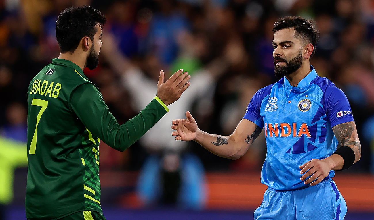 In the file photo, taken on October 23, 2022, India's Virat Kohli (R) shakes hands with Pakistan's Shadab Khan after the ICC men's Twenty20 World Cup 2022 cricket match between India and Pakistan at Melbourne Cricket Ground (MCG) in Melbourne. (AFP/File)