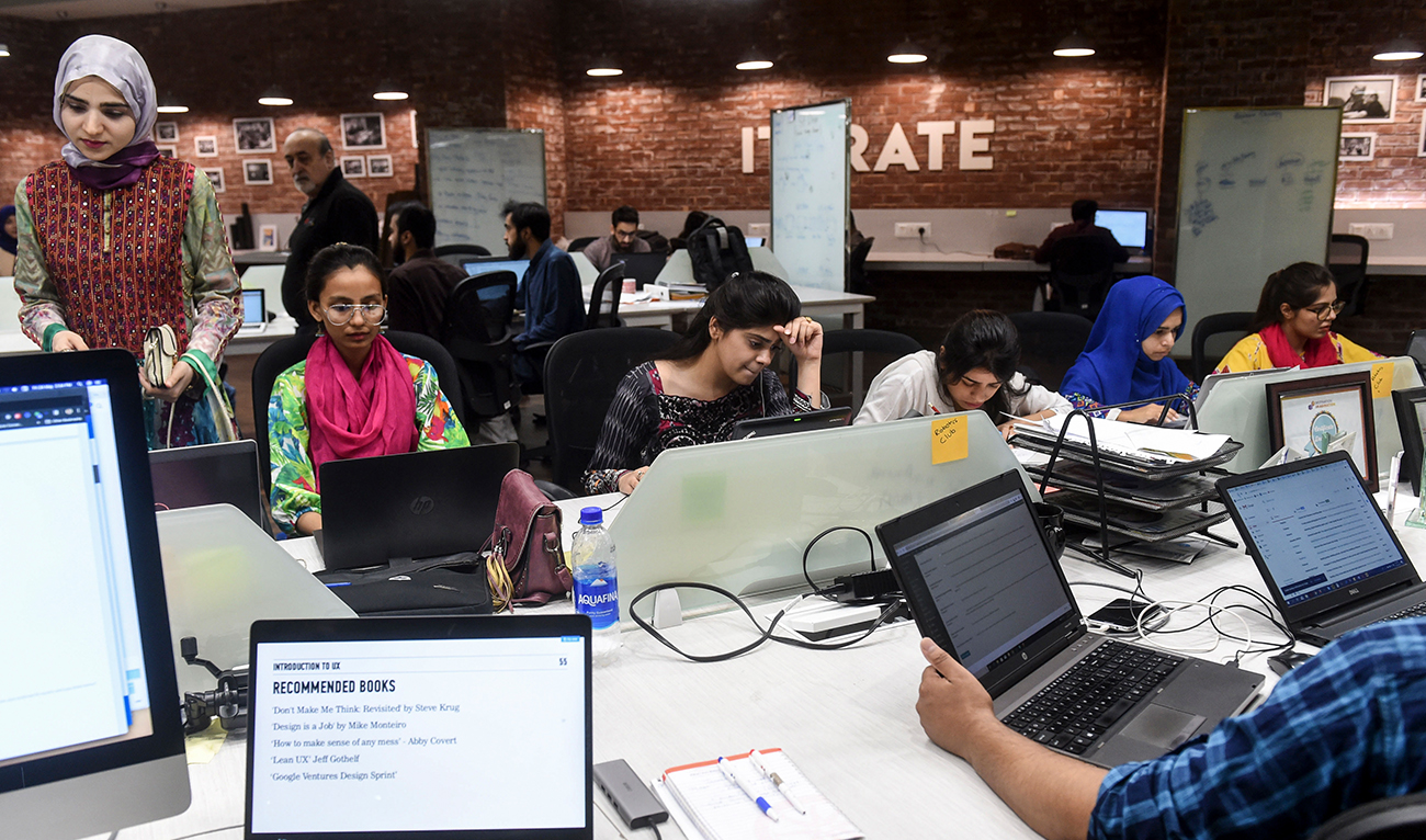 In this photograph taken on May 24, 2019, Pakistani youngsters work at their desks at the National Incubation Centre (NIC), in Lahore, Pakistan. (AFP/File)