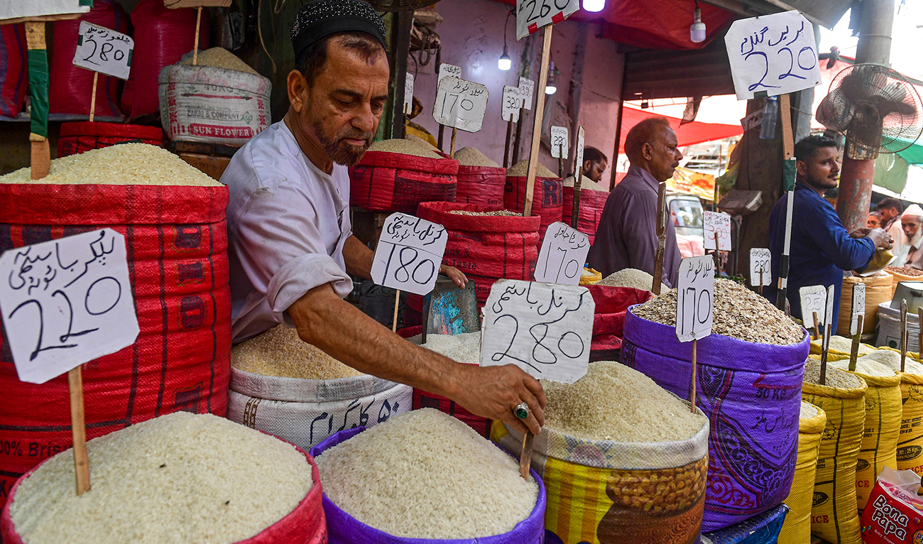 Shopkeepers sell cereals at a wholesale market in Karachi on June 8, 2023. (AFP/File)
