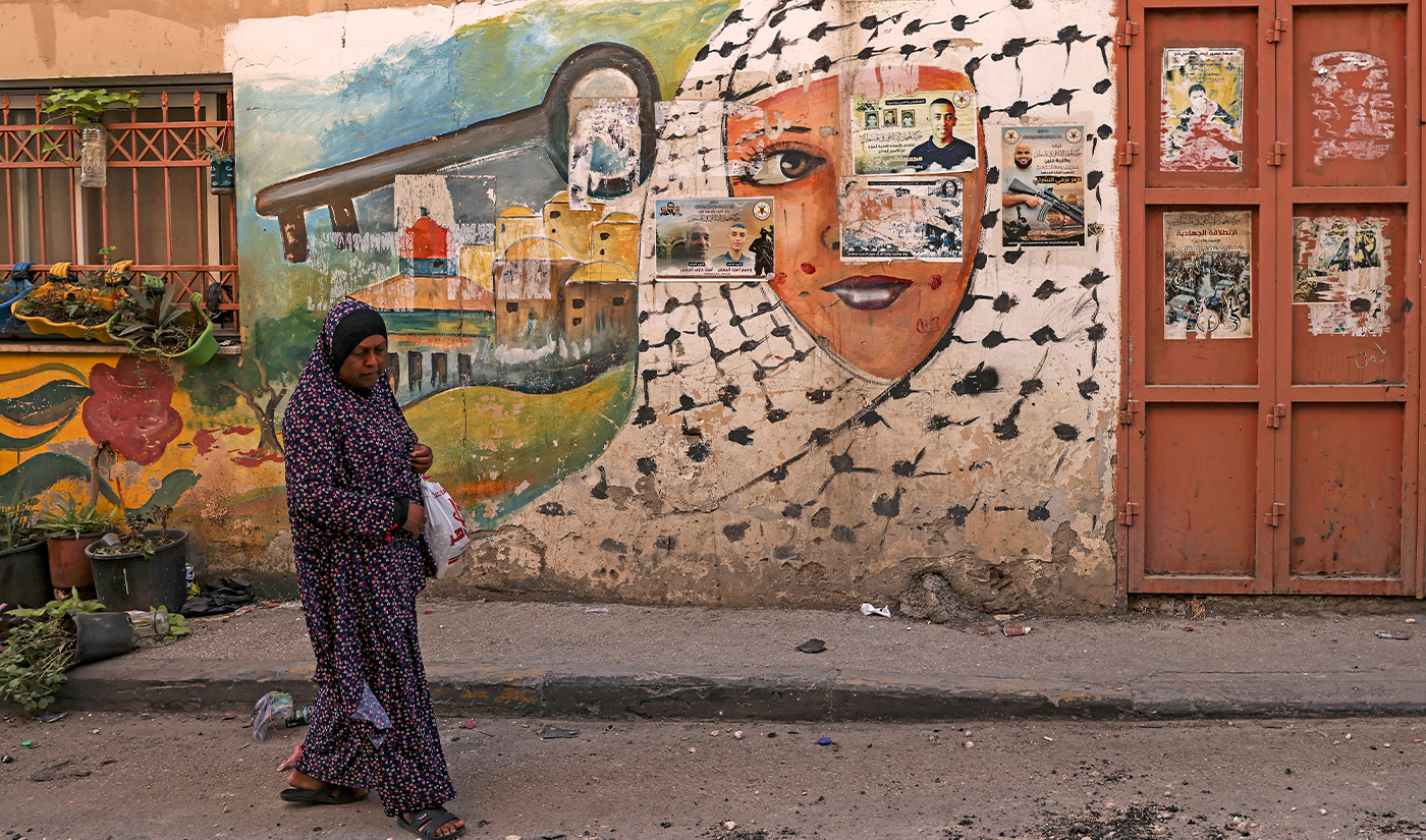 A woman walks past a mural in the aftermath of a military operation in Jenin refugee camp in the occupied West Bank on July 5, 2023. (AFP/File)