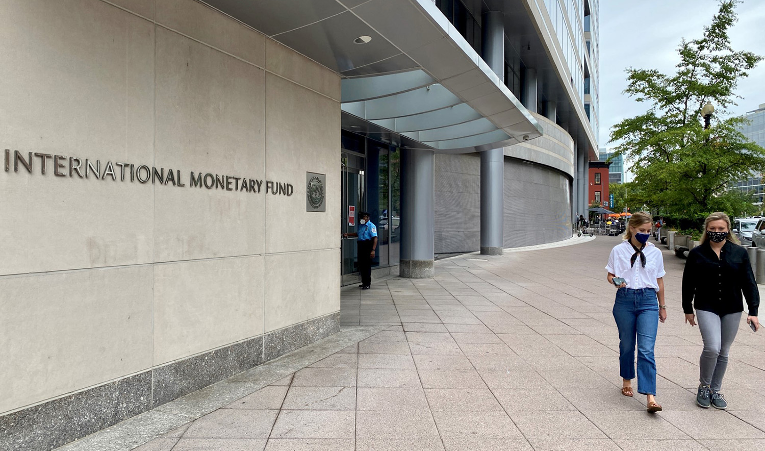People are walking in front of the International Monetary Fund (IMF) building in Washington DC on September 25, 2020. (AFP/File)