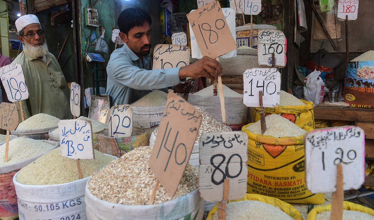 A shopkeeper place a price tag on rice at a shop in Karachi on June 10, 2022. (AFP/File)