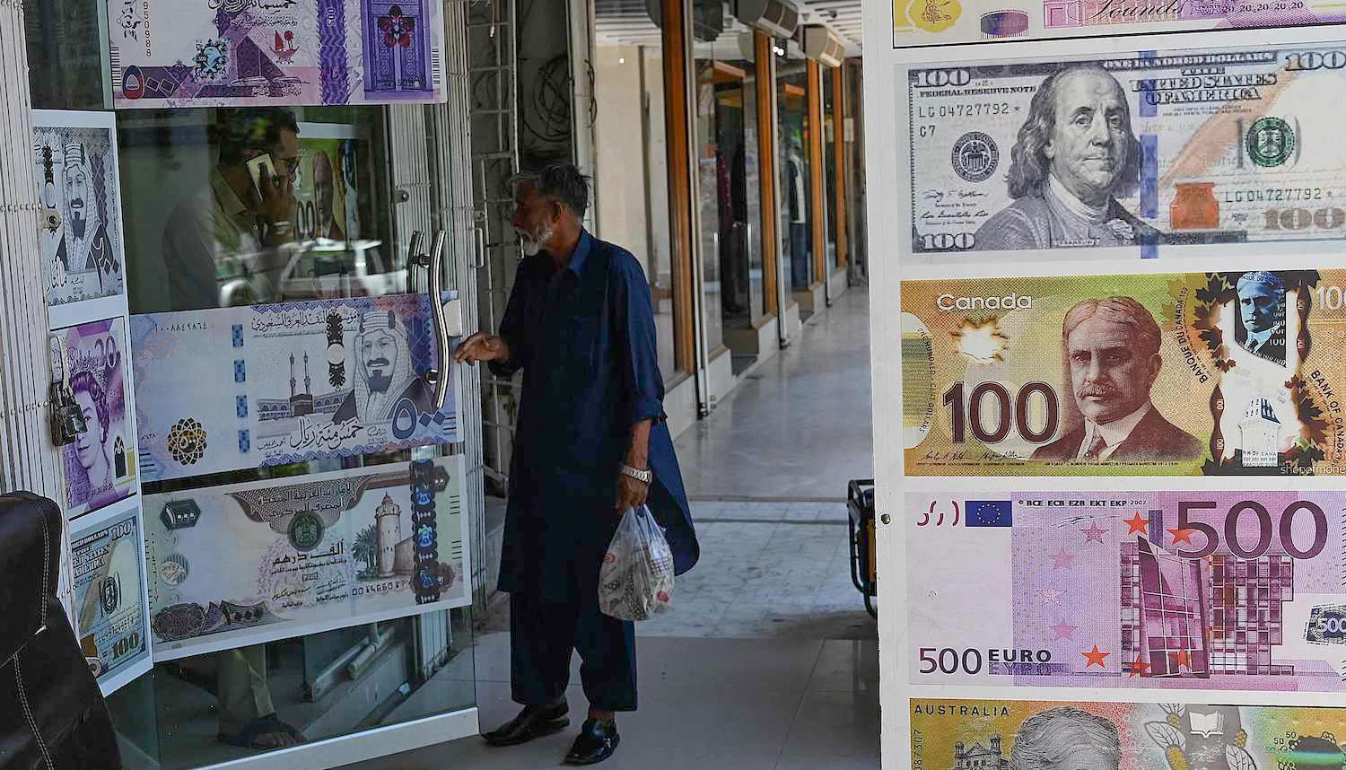 A man enters a foreign currency exchange shop in Islamabad, Pakistan on July 11, 2023. (AFP)