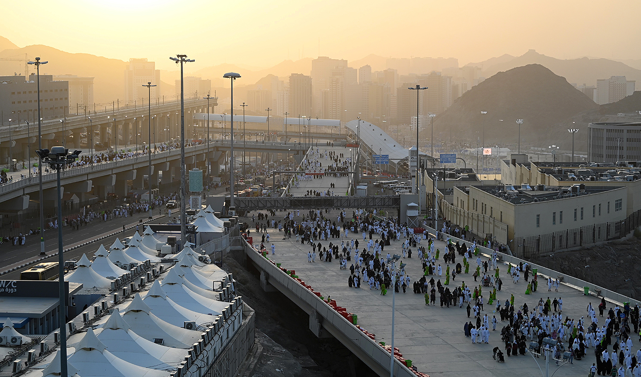 Pilgrims make their way across the valley of Mina near the holy Saudi city of Makkah, to perform the "stoning of the devil" ritual, during the annual Hajj pilgrimage, on June 28, 2023. (AFP)