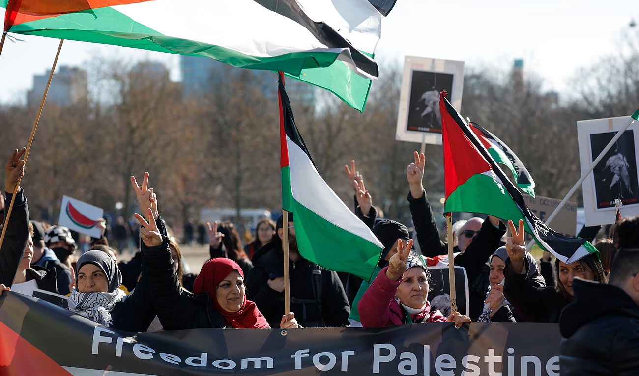 Demonstrators hold flags of Palestine as they protest on March 16, 2023 in front of the Bundestag (lower house of German parliament) in Berlin. (AFP/File)