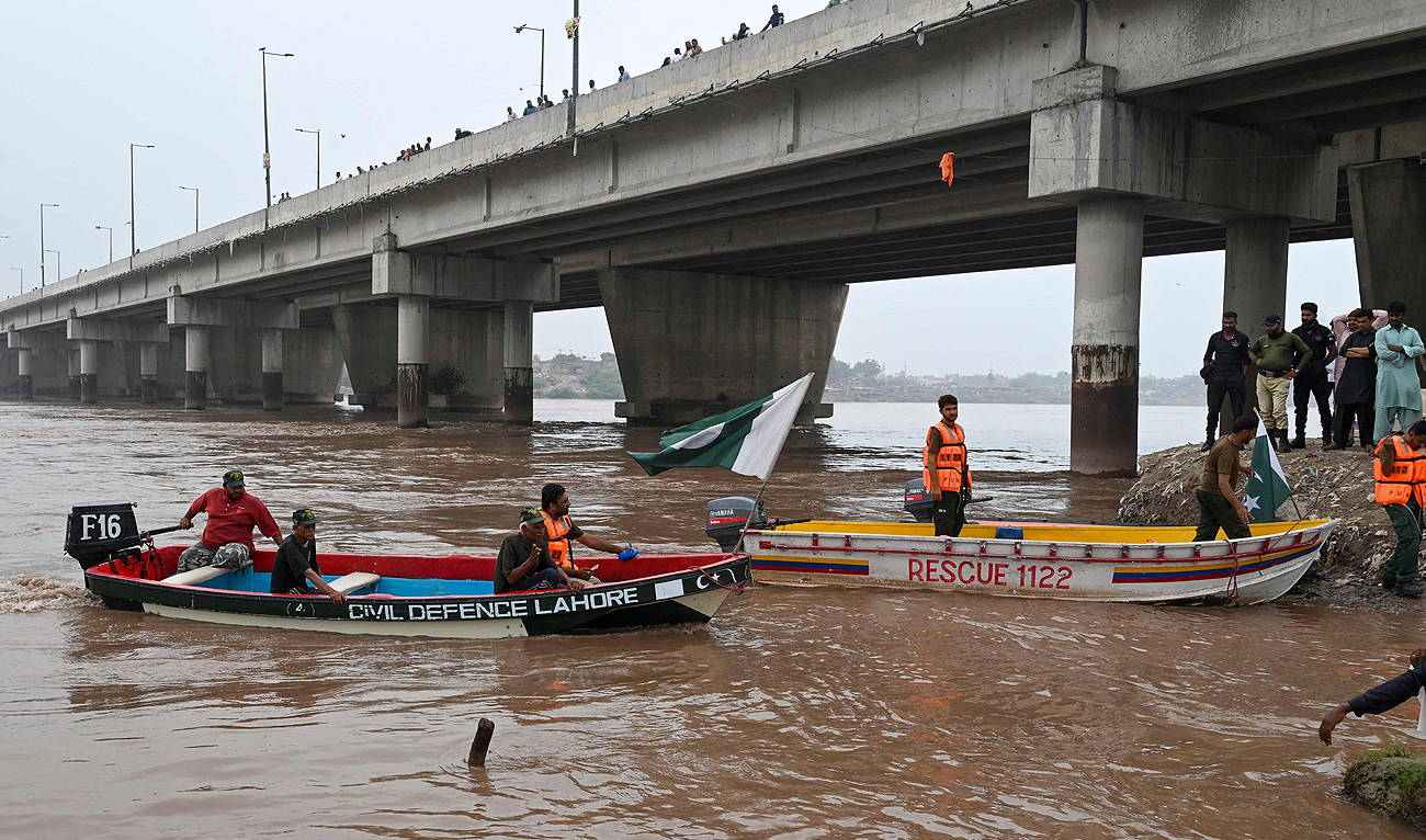 Pakistan's civil defence rescue workers monitor the flood-affected river Ravi in Lahore on July 16, 2023. (AFP)