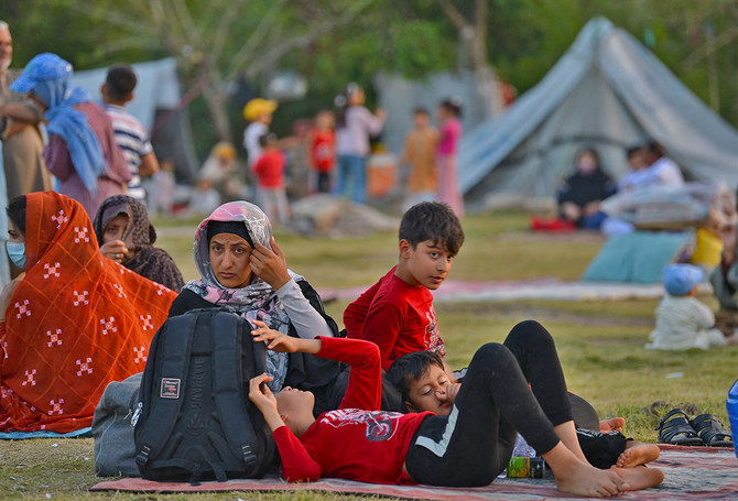 In this photo, taken on May 7, 2022, Afghan refugees seeking asylum abroad gather at an open field in protest to demand help from the United Nations High Commissioner for Refugees (UNHCR), in Islamabad, Pakistan. (AFP/File)