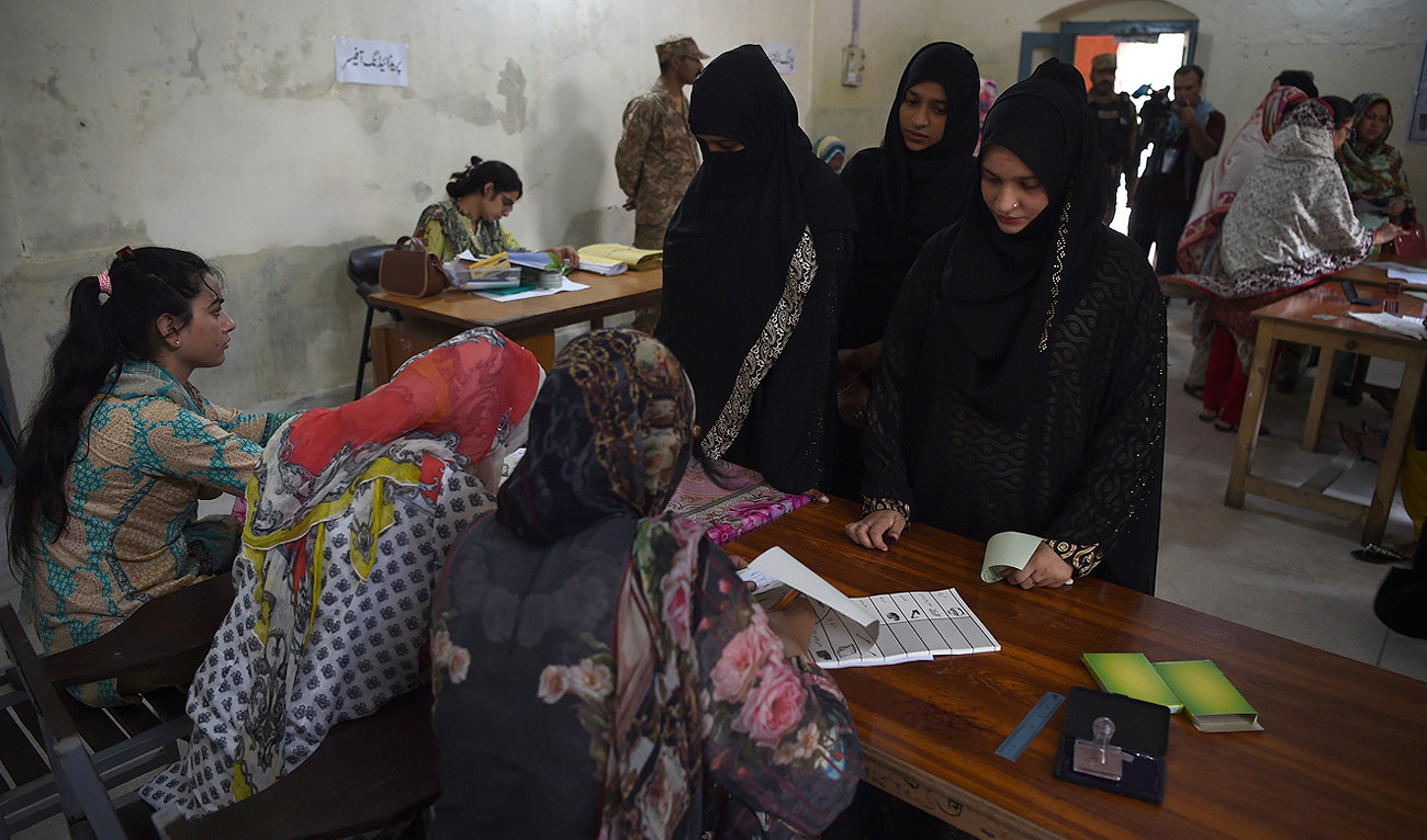 In this photo, taken on July 25, 2018, Pakistani women voters wait to get their ballot papers to cast their votes during Pakistan's general election at a polling station in Lahore. (AFP/File)