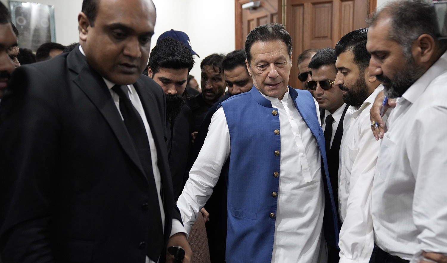 Pakistan's former Prime Minister Imran Khan arrives to sign documents as he submits surety bond over his bails in different cases at an office of Lahore High Court in Lahore, Pakistan, on July 18, 2023. (AP)
