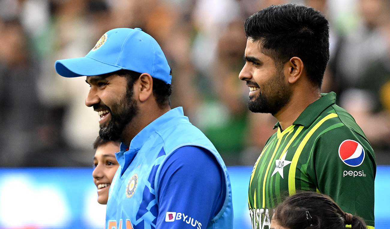 Pakistan's Captain Babar Azam (R) and India's captain Rohit Sharma walk into the ground during the ICC men's Twenty20 World Cup 2022 cricket match between India and Pakistan at Melbourne Cricket Ground (MCG) in Melbourne on October 23, 2022. (AFP/File)