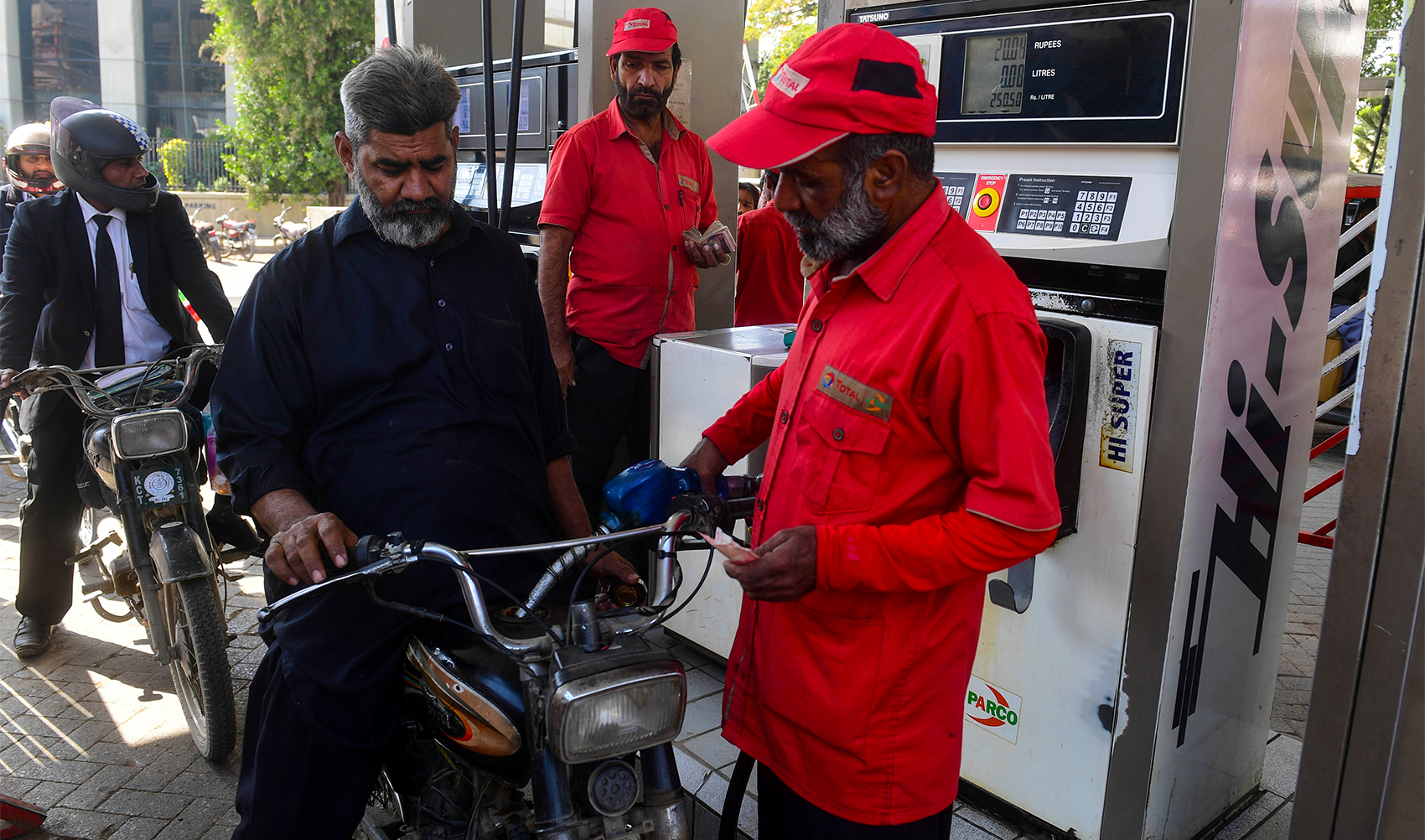 This picture taken on January 30, 2023, shows a man filling petrol in his motorcycle at a gasoline station in Pakistan's port city of Karachi. (AFP/File)