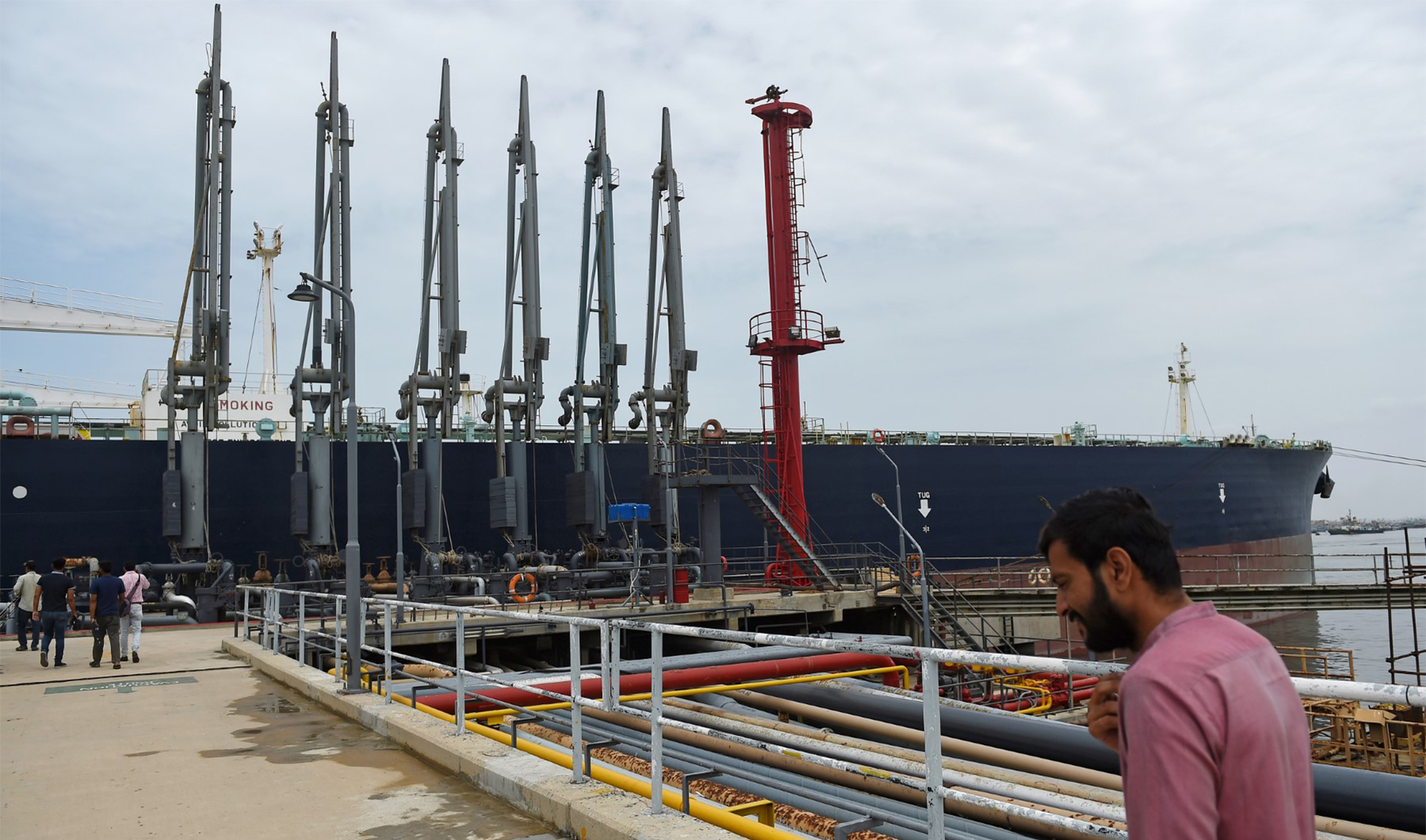 A man walks past a Russian cargo ship carrying crude oil docked at the Karachi port in Karachi on June 28, 2023. (AFP/File)