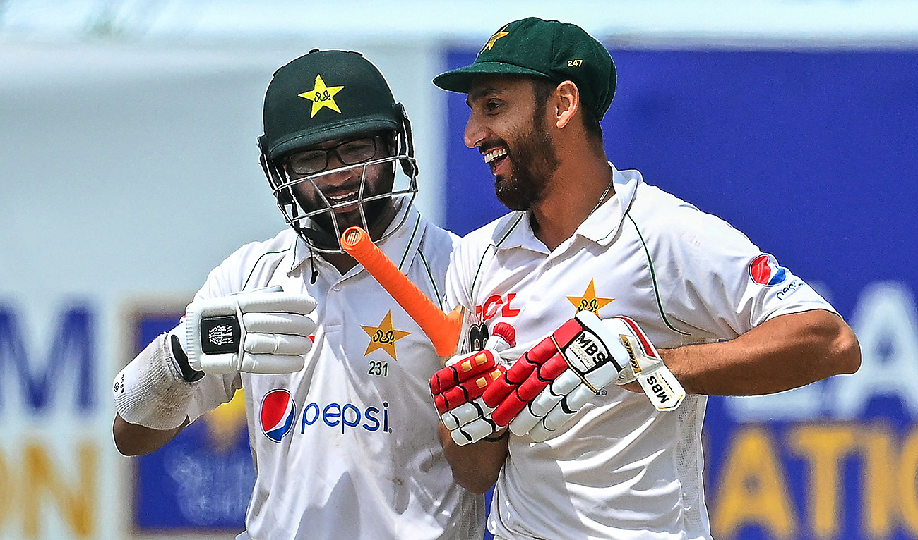 Pakistan's Imam-ul-Haq (L) and Agha Salman walk back to the pavilion after Pakistan won by 4 wickets on the fifth and final day of play of the first cricket Test match between Sri Lanka and Pakistan at the Galle International Cricket Stadium in Galle on July 20, 2023. (AFP)