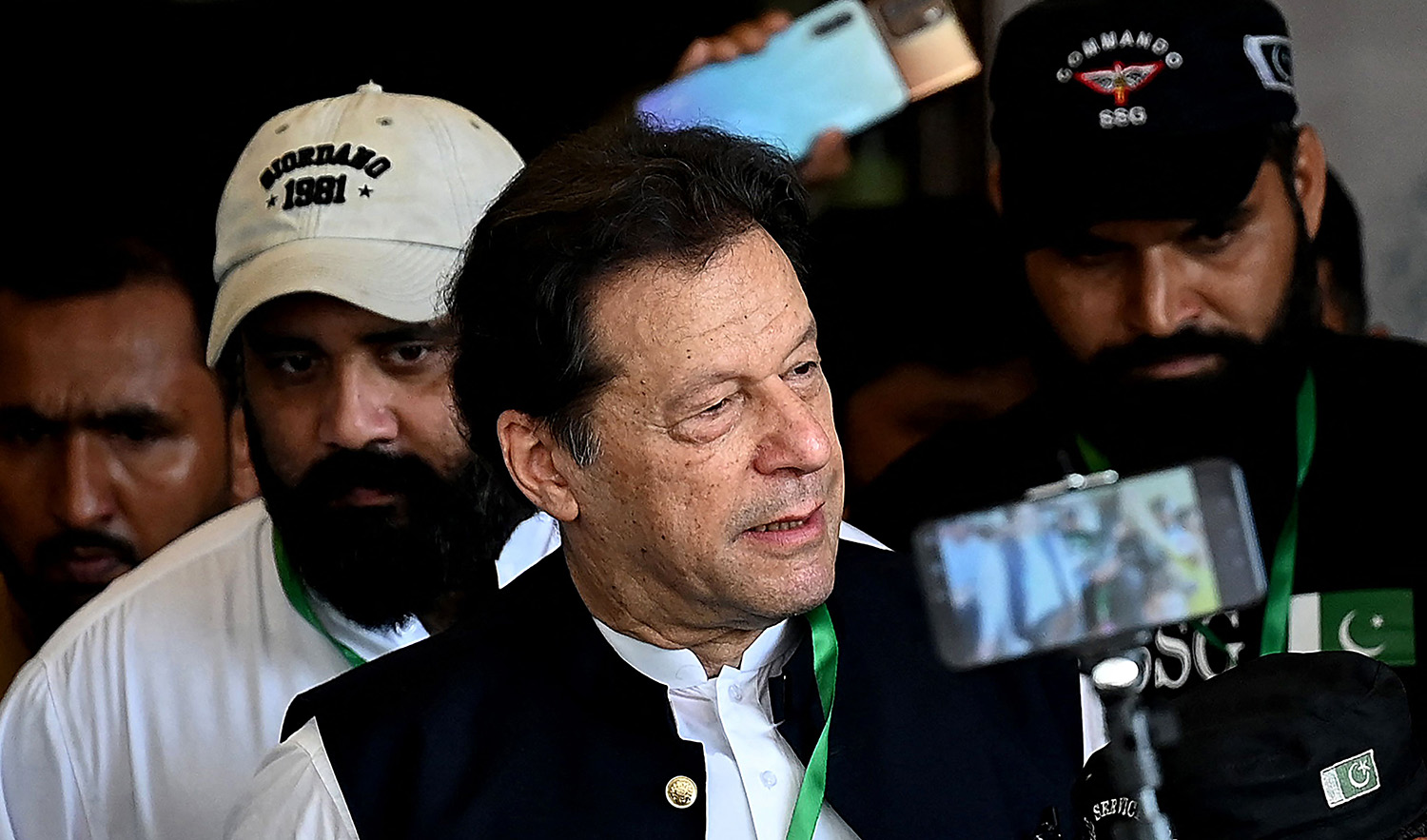 Pakistan's former prime minister Imran Khan, center, leaves after appearing in the Supreme Court in Islamabad on July 26, 2023. (AFP)