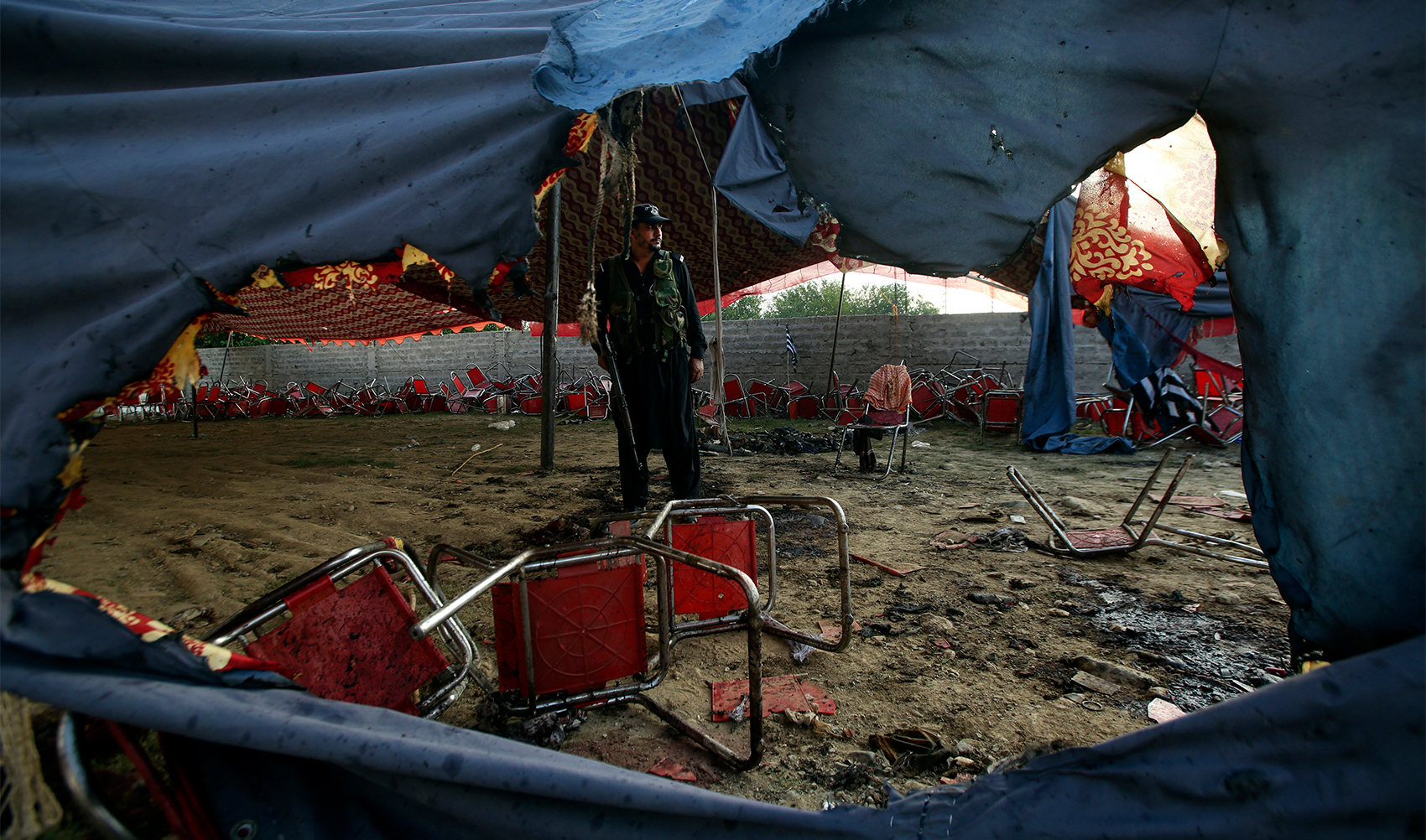 A Pakistani police officer stand guard at the site of Sunday's suicide bomber attack in the Bajaur district of Khyber Pakhtunkhwa, Pakistan, on July 31, 2023. (AP)