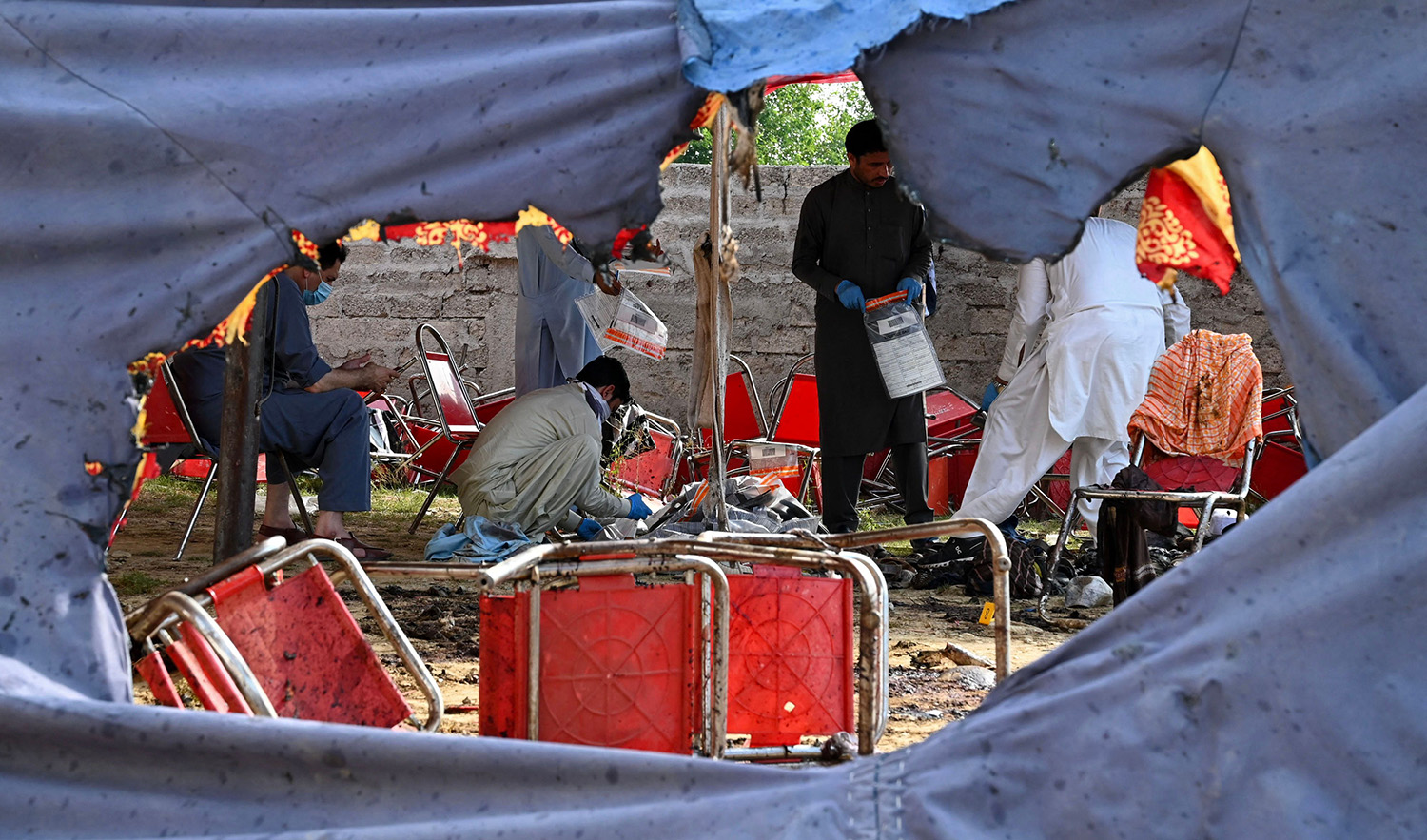 Police officials examine the site of a bomb blast in Bajaur district of Pakistan's Khyber-Pakhtunkhwa province on July 31, 2023. (AFP)