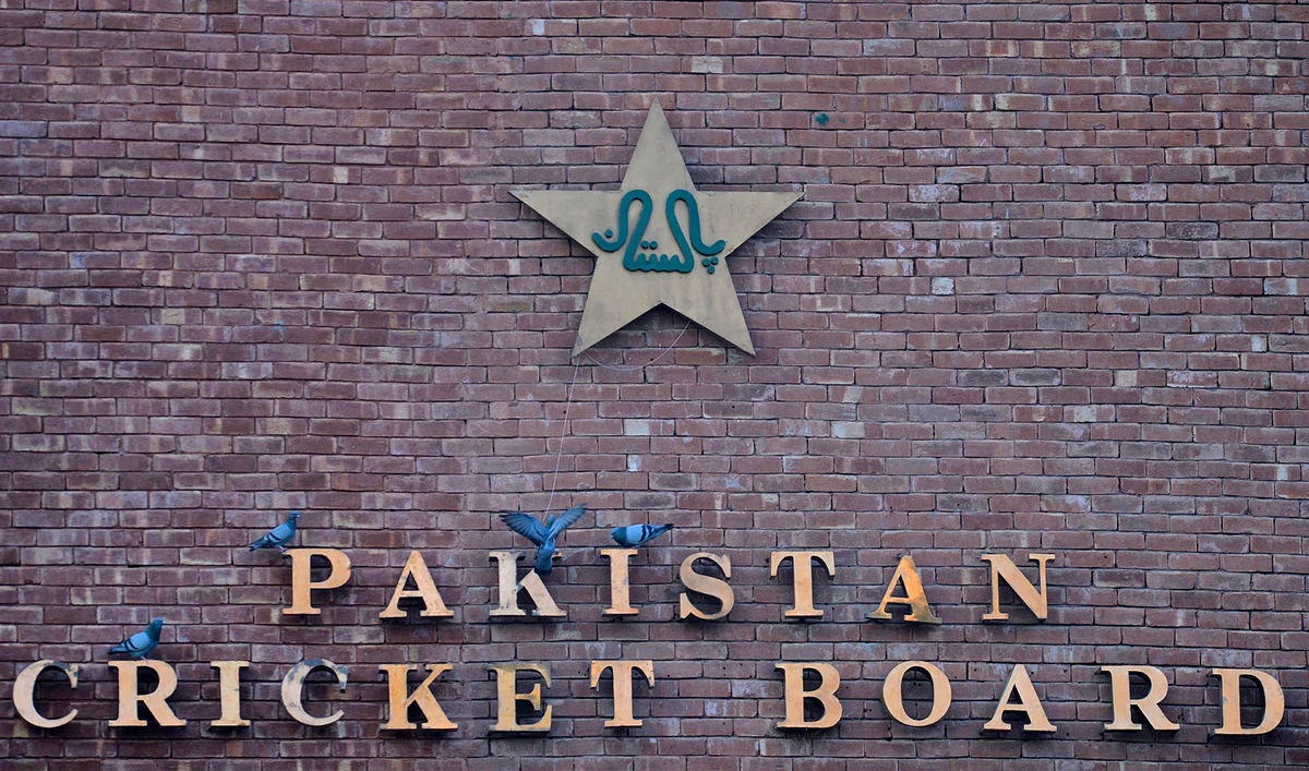 This picture taken on September 7, 2017 shows pigeons resting on a sign for the Pakistan Cricket Board at the Gaddafi Stadium in Lahore. (AFP/File)