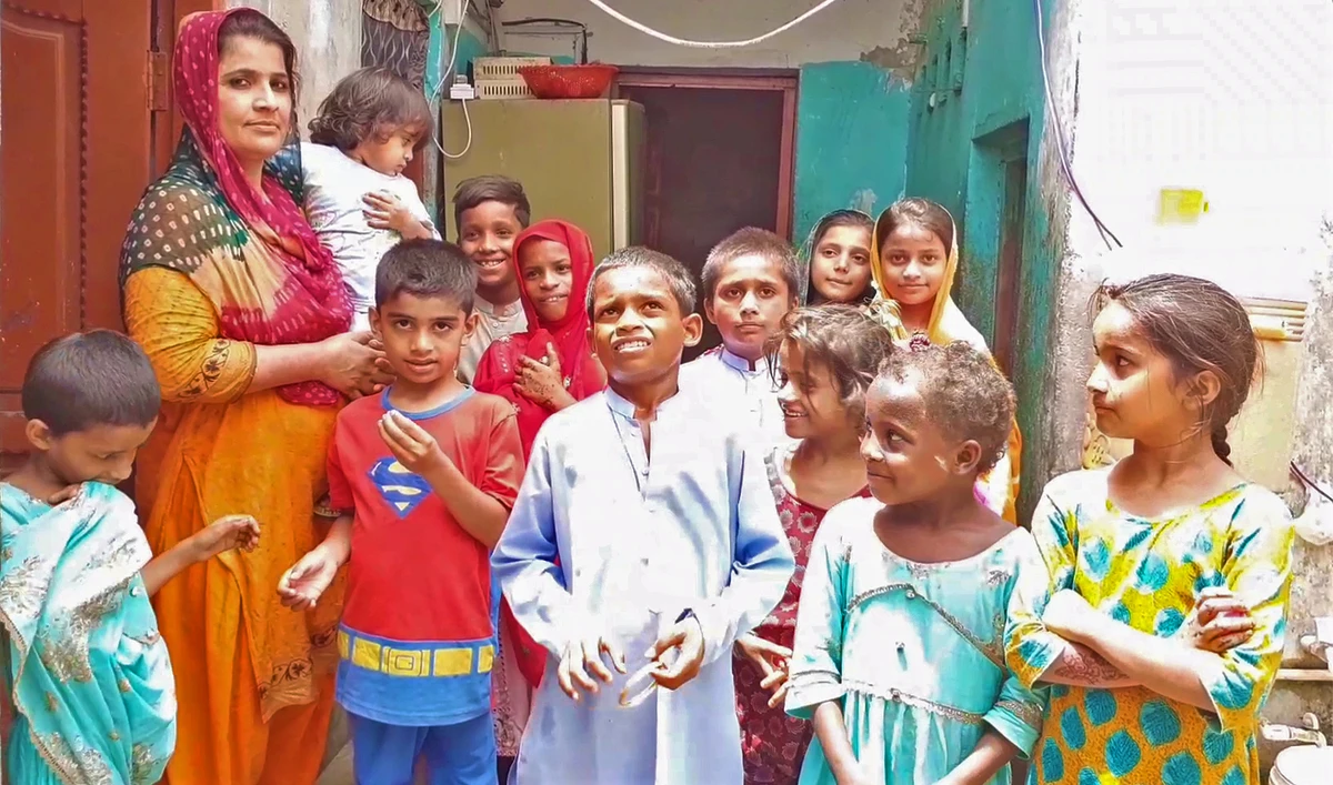 Razia Sahto is pictured with children at her orphanage house in Tando Muhammad Khan, Sindh, on July 6, 2023. (AN photo)