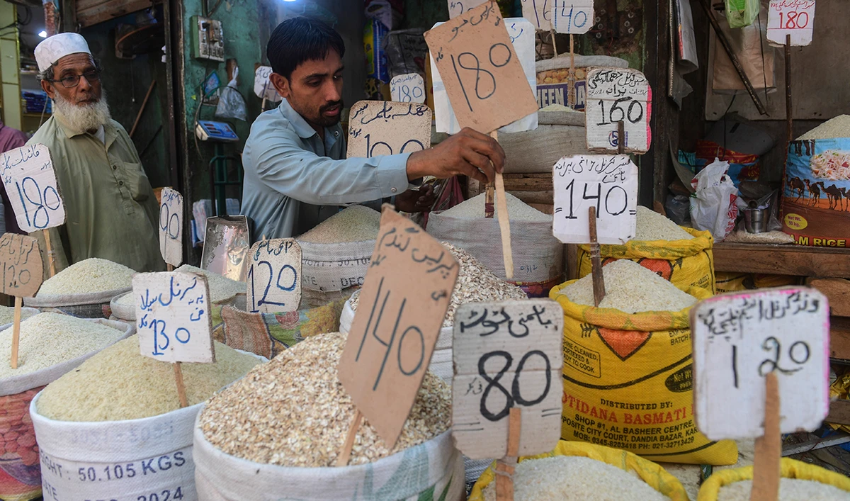 A shopkeeper place a price tag on rice at a shop in Karachi on June 10, 2022. (AFP/File)