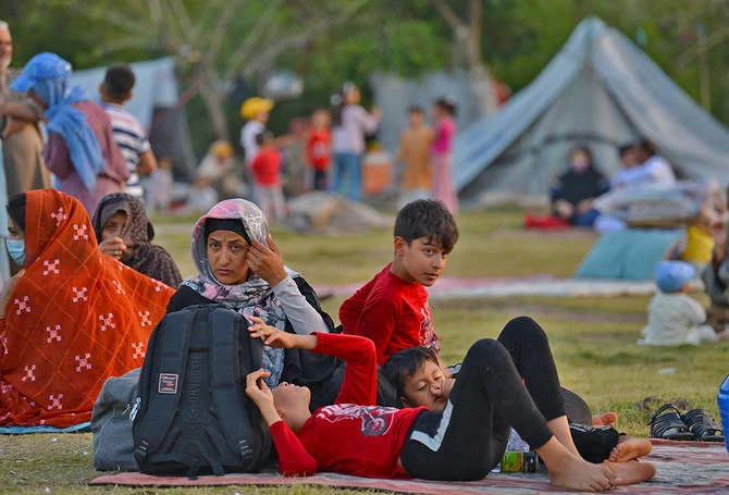 In this photo, taken on May 7, 2022, Afghan refugees seeking asylum abroad gather at an open field in protest to demand help from the United Nations High Commissioner for Refugees (UNHCR), in Islamabad, Pakistan. (AFP/File)