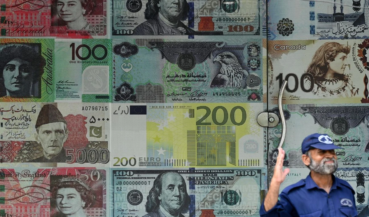 A security guard stands outside a currency exchange shop in Rawalpindi on July 15, 2023. (AFP/File)