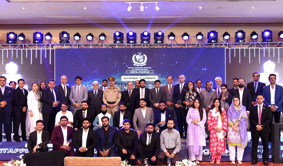 Pakistan Prime Minister Shehbaz Sharif and Army Chief General Asim Munir along with other government officials pose for a group photo with entrepreneurs during the National IT Seminar in Islamabad on July 20, 2023. (Photo courtesy: Twitter/PakPMO)