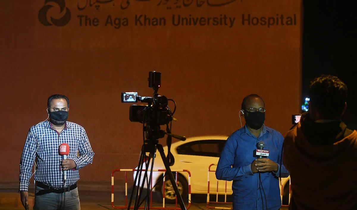 Pakistani journalists report outside the Aga Khan University Hospital in Karachi on February 26, 2020. (AFP/File)