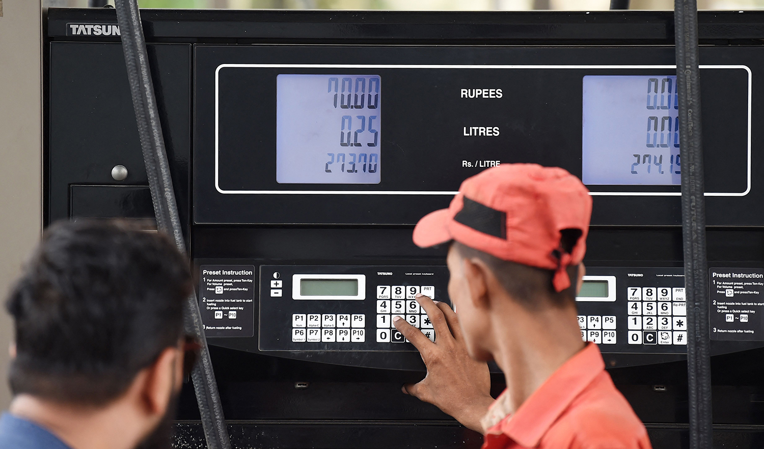 An employee prepares to fill petrol in a vehicle at a fuel station in Karachi, Pakistan on August 1, 2023. (AFP)