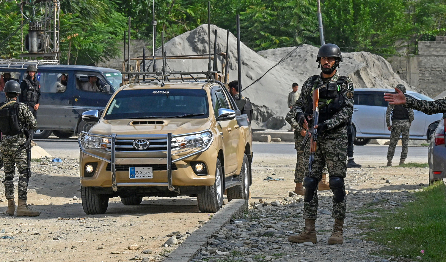 Security personnel stand guard at the site of a bomb blast in Bajaur district of Pakistan's Khyber Pakhtunkhwa province on July 31, 2023. (AFP)
