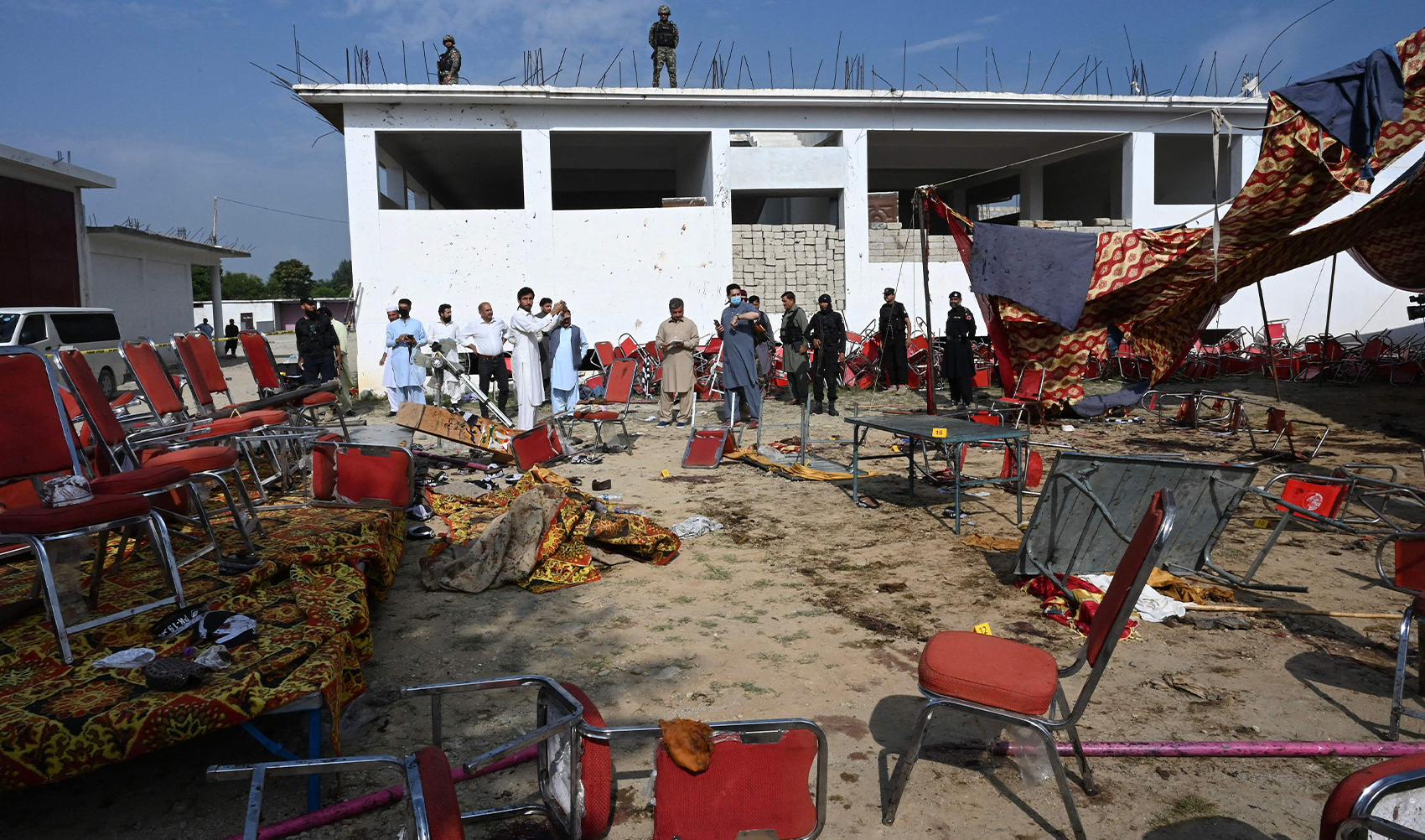 Security personnel examine the site of a bomb blast in Bajaur district of Khyber-Pakhtunkhwa province on July 31, 2023. (AFP)