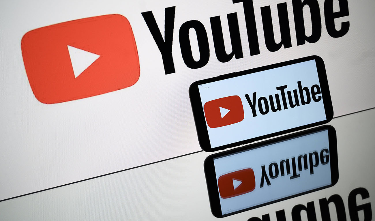 A picture taken on October 5, 2021 in Toulouse shows the logo of Youtube social media displayed by a by a tablet and a smartphone. (AFP/File)