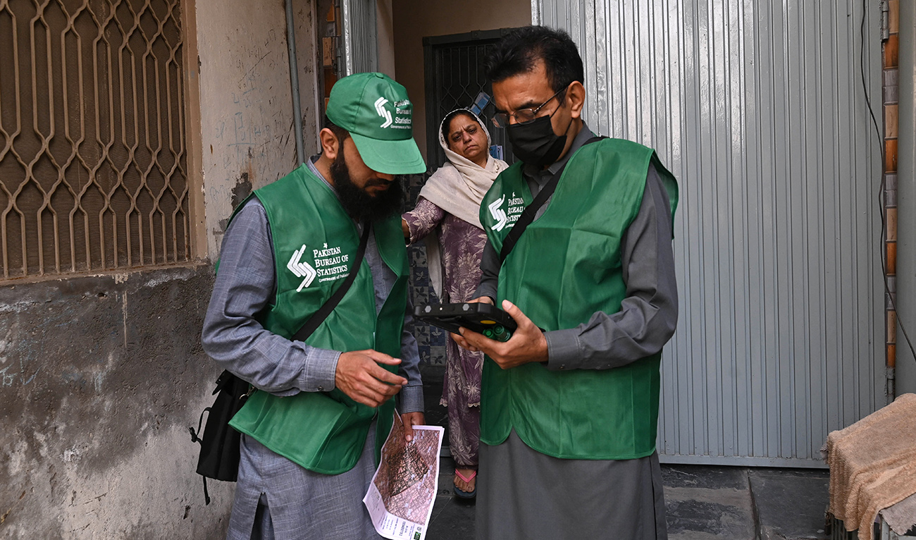 An official from the Pakistan Bureau of Statistics uses a digital device to collect information from a resident during door-to-door the first ever digital national census in Lahore on March 1, 2023. (AFP/FILE)