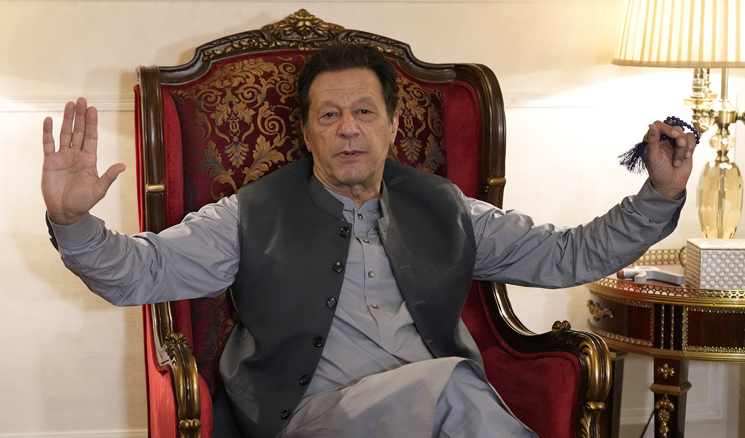Pakistan's former prime minister Imran Khan talks with reporters regarding the current political situation and the ongoing cases against him at his residence, in Lahore, Pakistan, on August 3, 2023. (AP)