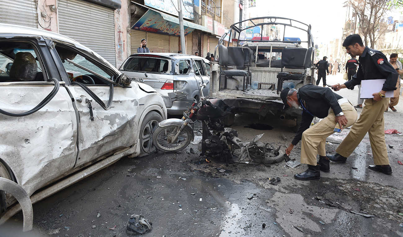 Police officials examine the site of a bomb blast in Quetta on April 10, 2023. (AFP/File)