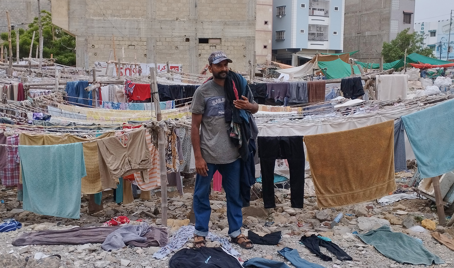 Muhammad Asif, a washerman stands at his clothe drying yard in the Lines Area of Karachi, Pakistan, on July 31,2023. Asif says traditional washermen suffer due to high prices and declining business. (AN photo)