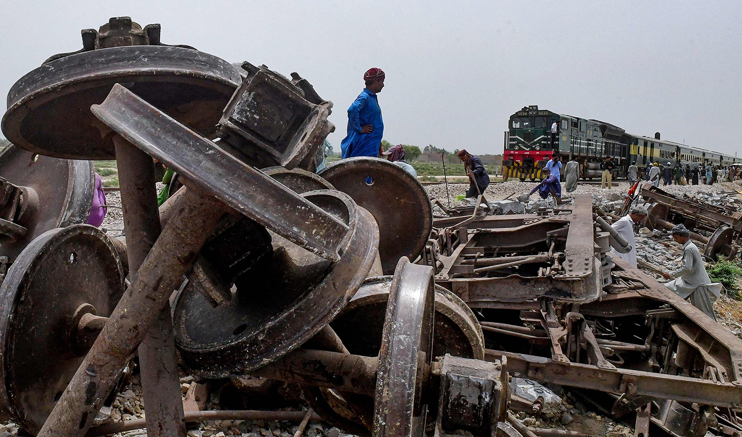Workers repair a damaged track, a day after the derailment of a passenger train in Nawabshah, Pakistan, on August 7, 2023. (AFP)
