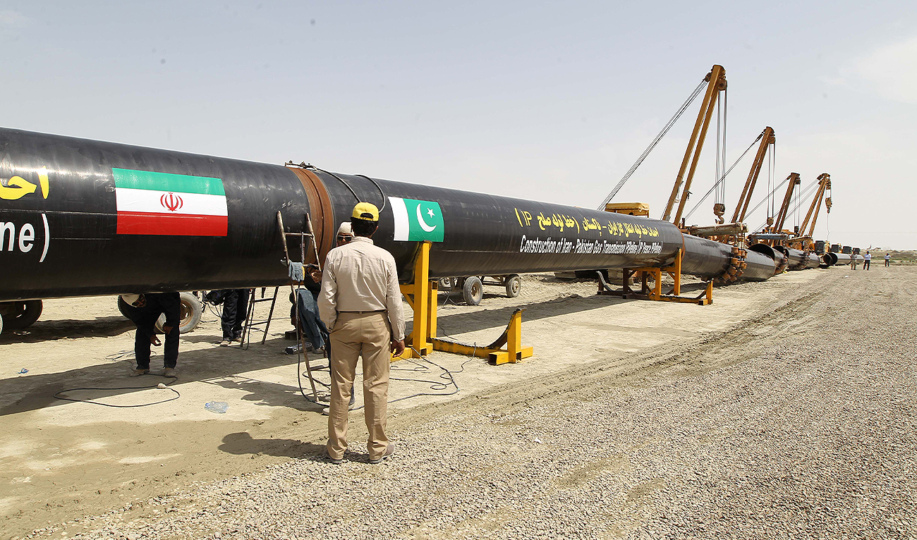 An Iranian worker stands in front of a section of a pipeline after the project was launched during a ceremony with presidents of Iran and Pakistan on March 11, 2013 in the Iranian border city of Chah Bahar. (AFP/File)