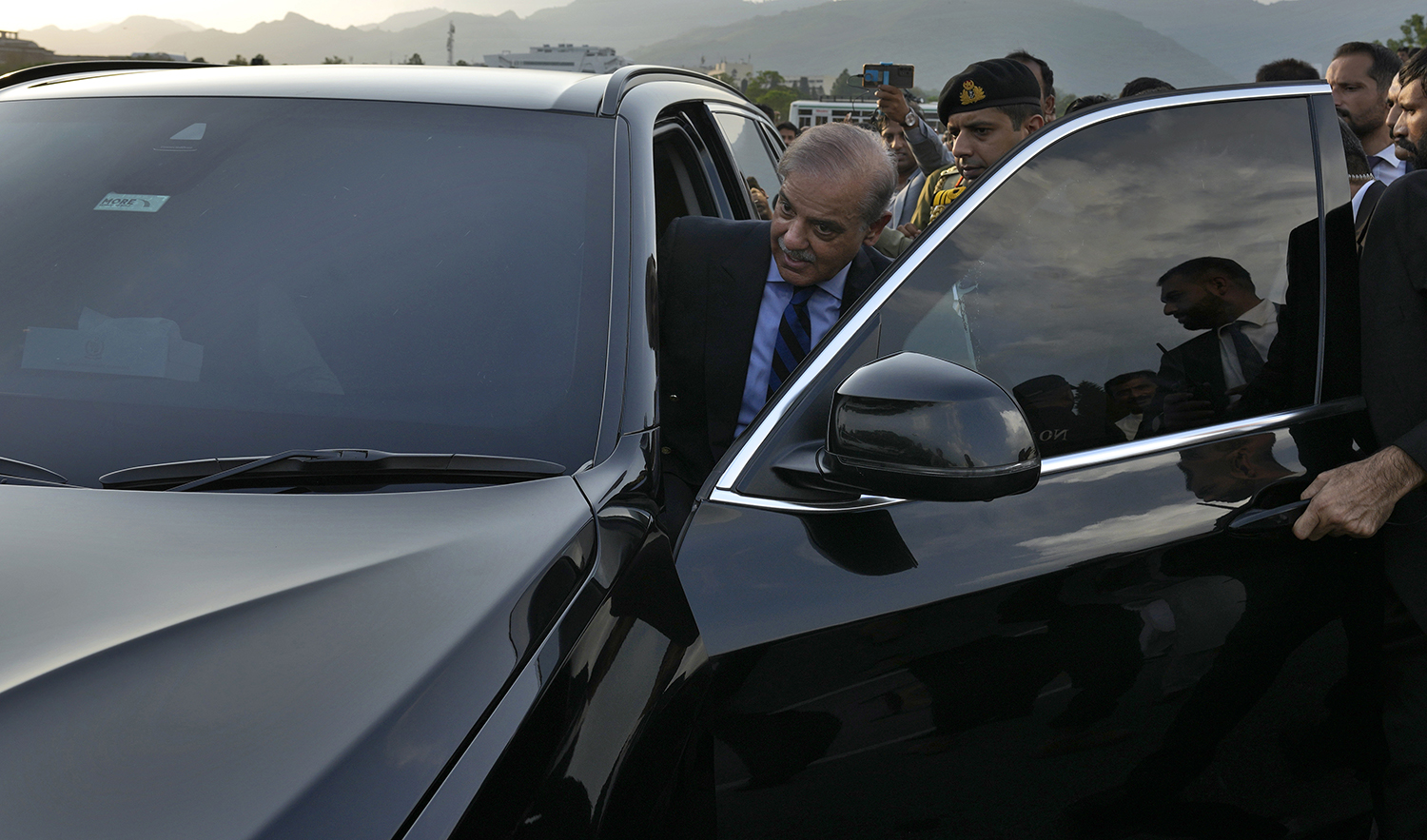 Pakistan's Prime Minister Shehbaz Sharif leaves after a group photo with lawmakers of the National Assembly at the end of the last session of the current parliament, in Islamabad, Pakistan, on August 9, 2023. (AP)