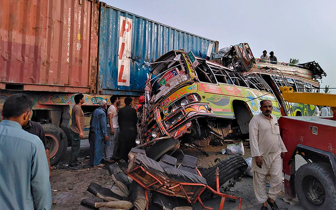 Residents and rescue workers at the site of a deadly bus accident near Dera Ghazi Khan, Pakistan, on July 19, 2021. (AP/File)