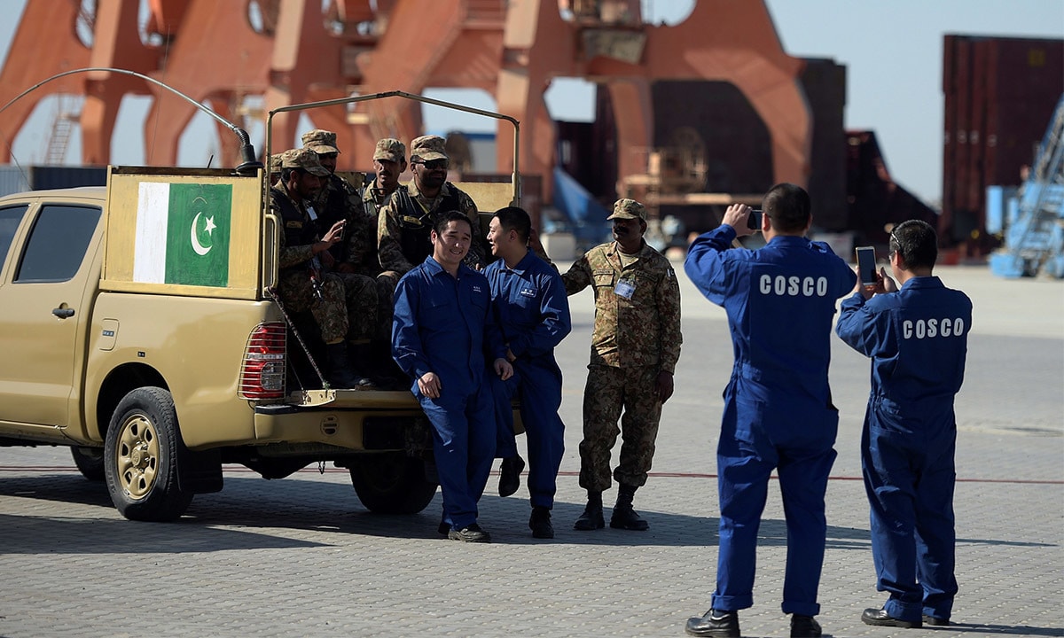 Chinese workers pose for a picture with Pakistani soldiers in Gwadar port, Pakistan. (AFP/File)
