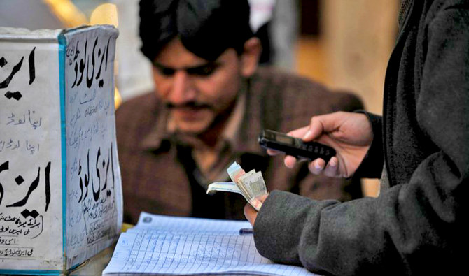 A Pakistani vendor counts currency notes at his roadside stall in Islamabad, Pakistan, on December 15, 2011. (AFP/File)