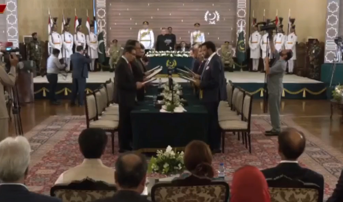 In this screengrab taken from Pakistan Television's live broadcast, Caretaker PM Anwaar-ul-Haq Kakar's cabinet takes oath at the President's House in Islamabad on August 17, 2023. (Photo courtesy: PTV/Screengrab)