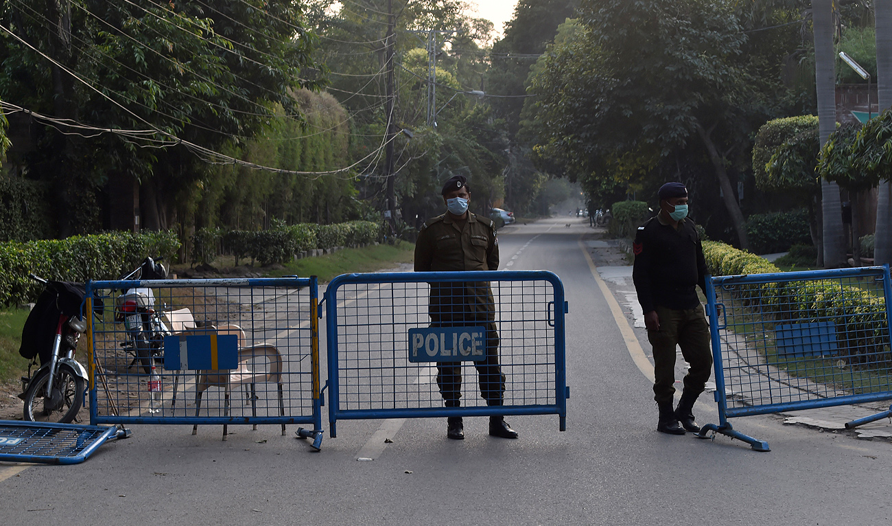 In this file photo, taken on November 19, 2020, policemen stand guard as they block a street in Lahore. (AFP/File)