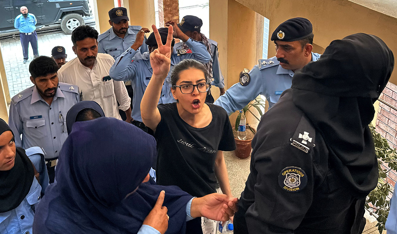 Police officials presents arrested lawyer and human rights activist Imaan Mazari-Hazir, center, before a court in Islamabad, Pakistan on August 20, 2023. (AFP)
