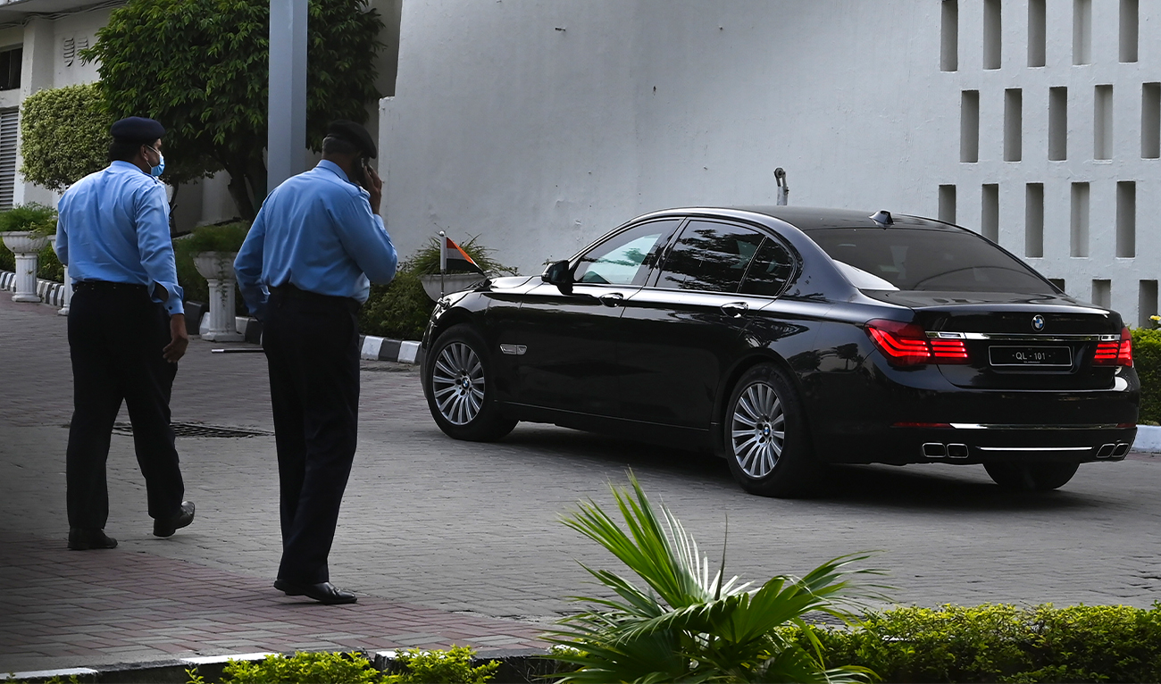 Police officers watch a car carrying Indian diplomats to the Pakistan's Foreign Ministry in Islamabad on July 16, 2020. (Photo courtesy: AFP/File)