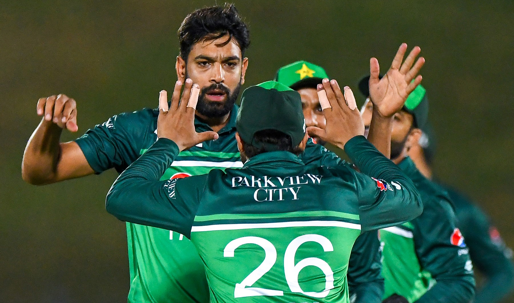 Pakistan's Haris Rauf (L) celebrates with teammates after taking the wicket of Afghanistan's Ikram Alikhil (not pictured) during the first one-day international (ODI) cricket match between Pakistan and Afghanistan at the Mahinda Rajapaksa International Cricket Stadium in Hambantota, Sri Lanka, on August 22, 2023. (Photo courtesy: AFP)